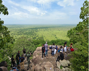 people gathered on a rock at shai hills